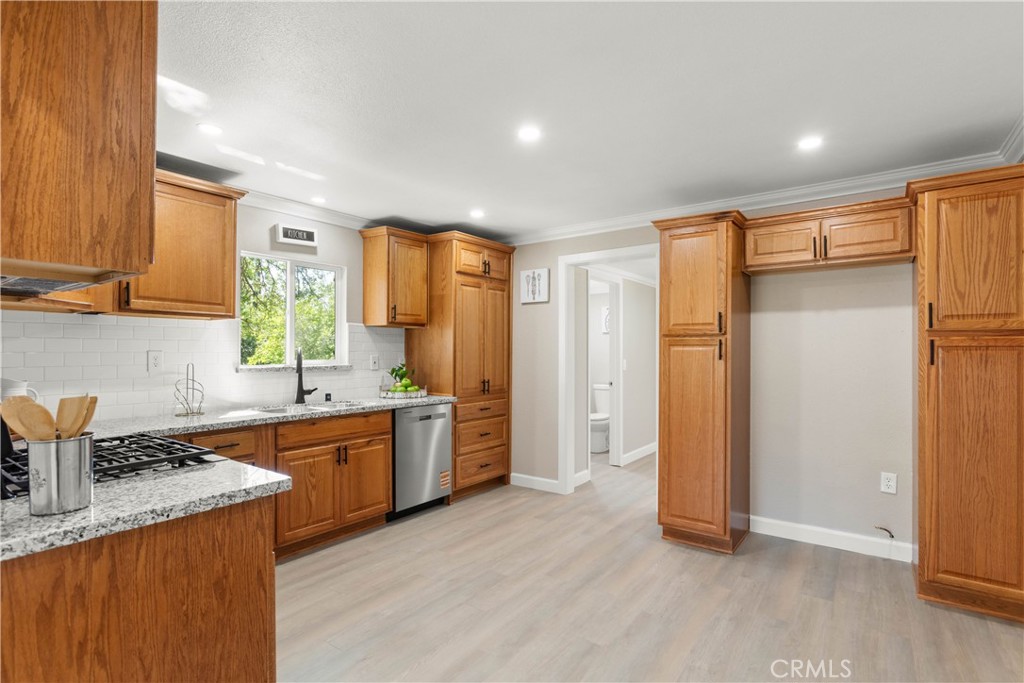 4936 Lower Wyandotte Road Oroville, CA 95966 - Photo 9 of 41 a kitchen with stainless steel appliances granite countertop a refrigerator and a sink