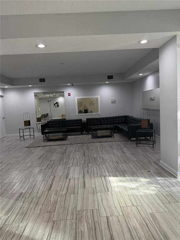 2121 McCoy Road, Unit 337 Orlando, FL 32809 - Photo 13 of 22 a living room with furniture and a wooden floor