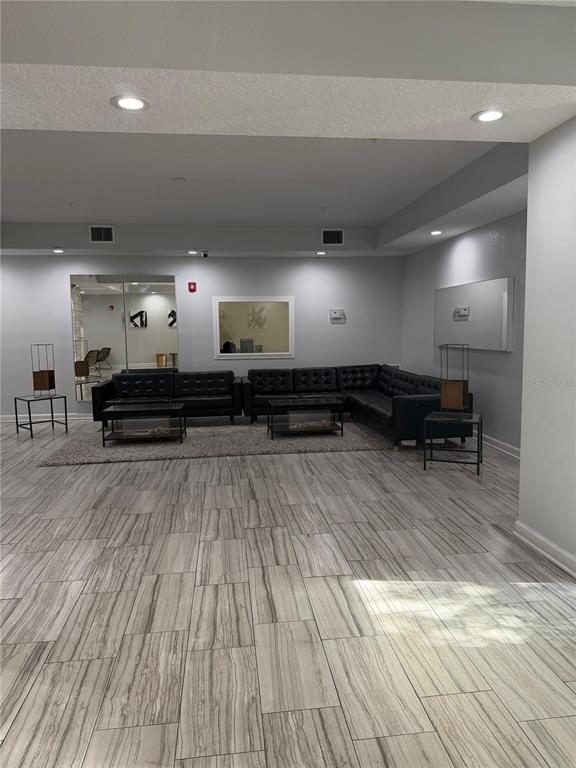 2121 McCoy Road, Unit 337 Orlando, FL 32809 - Photo 16 of 22 a living room with furniture and a chandelier