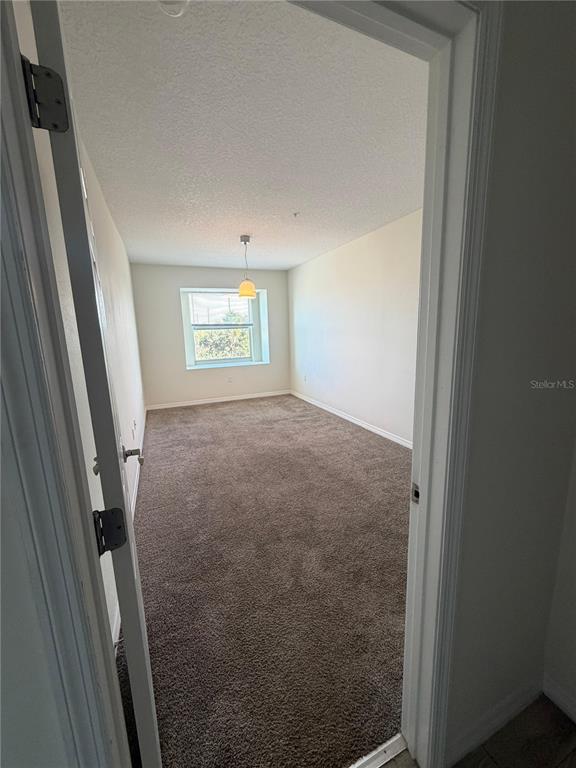 2121 McCoy Road, Unit 337 Orlando, FL 32809 - Photo 3 of 22 a view of a hallway with a window