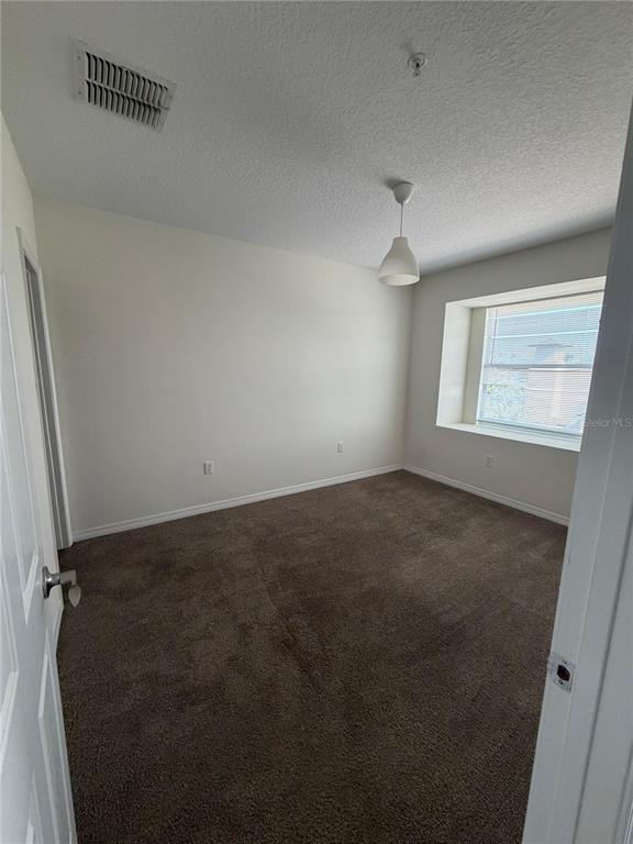 2121 McCoy Road, Unit 337 Orlando, FL 32809 - Photo 6 of 22 an empty room with windows and cabinet
