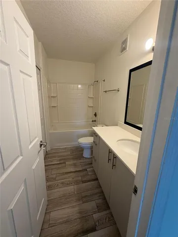 a bathroom with toilet sink and mirror