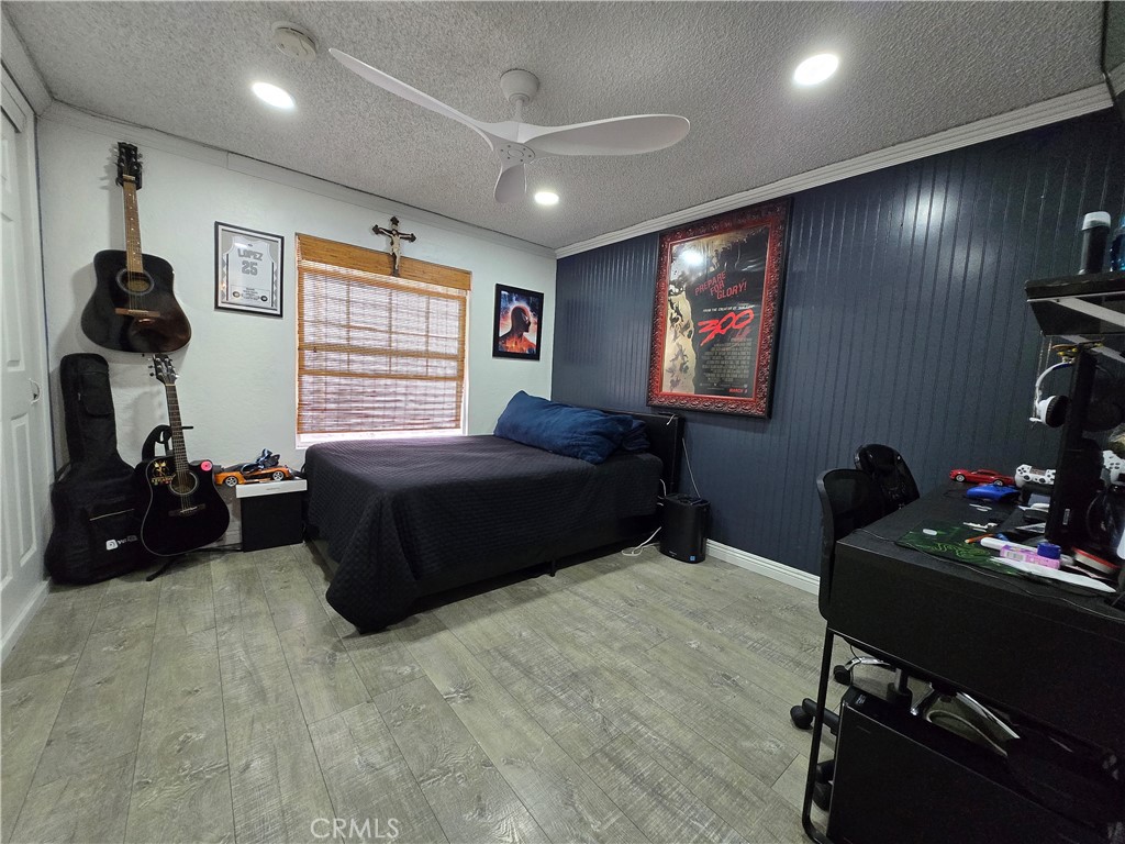 12401 Filmore Street Sylmar, CA 91342 - Photo 11 of 17 a bedroom with a bed and a gym equipment