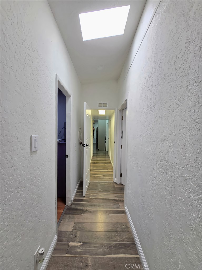 12401 Filmore Street Sylmar, CA 91342 - Photo 13 of 17 a view of a hallway with wooden floor and stairs