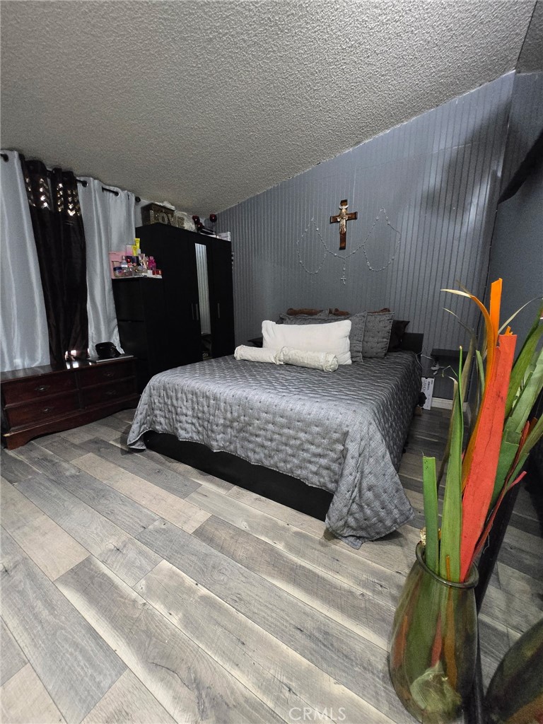 12401 Filmore Street Sylmar, CA 91342 - Photo 15 of 17 a bedroom with a bed and a walk in closet