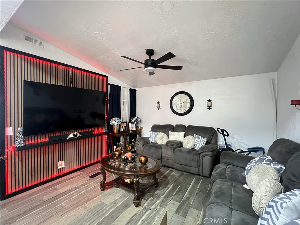 12401 Filmore Street Sylmar, CA 91342 - Photo 6 of 17 a living room with furniture and a flat screen tv