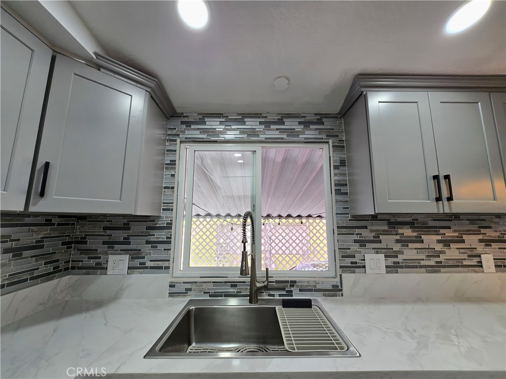 12401 Filmore Street Sylmar, CA 91342 - Photo 8 of 17 a kitchen with a sink a window and cabinets