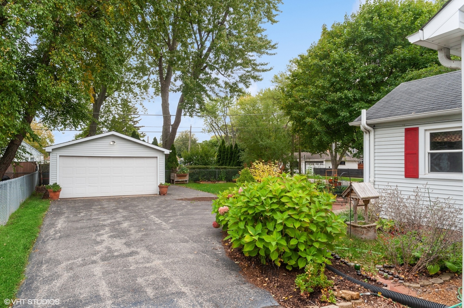 205 Wheeling Avenue Wheeling, IL 60090 - Photo 22 of 25 a view of a house with a yard and potted plants