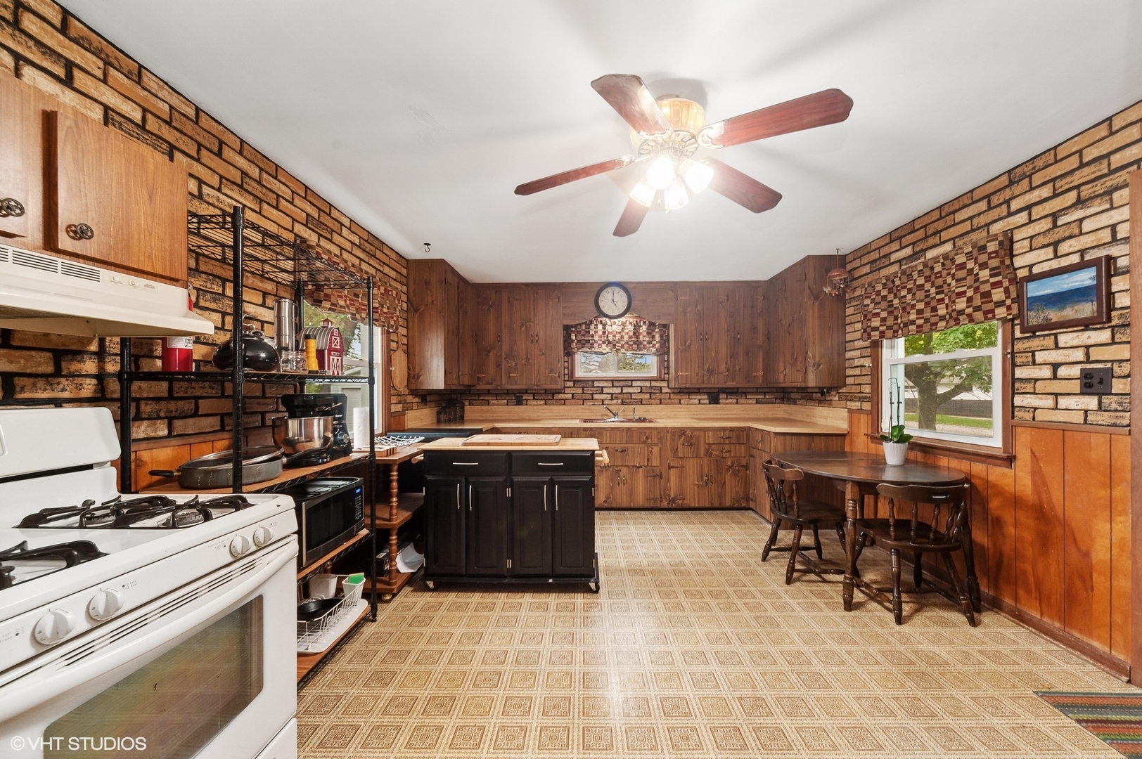 205 Wheeling Avenue Wheeling, IL 60090 - Photo 8 of 25 a kitchen with a sink stainless steel appliances and cabinets