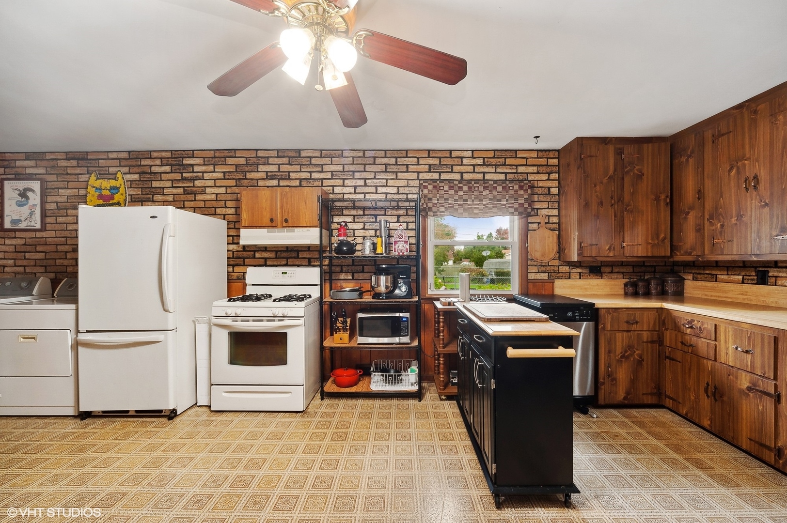 205 Wheeling Avenue Wheeling, IL 60090 - Photo 9 of 25 a kitchen with stainless steel appliances granite countertop a stove a sink and a refrigerator