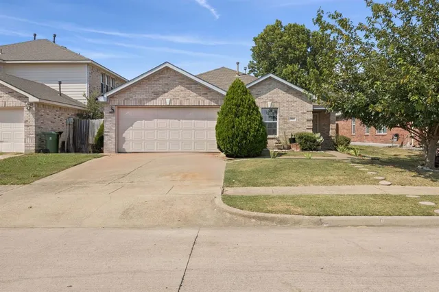 a view of a house with a yard and garage