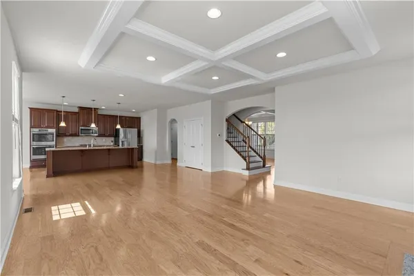 a view of kitchen and hall with wooden floor