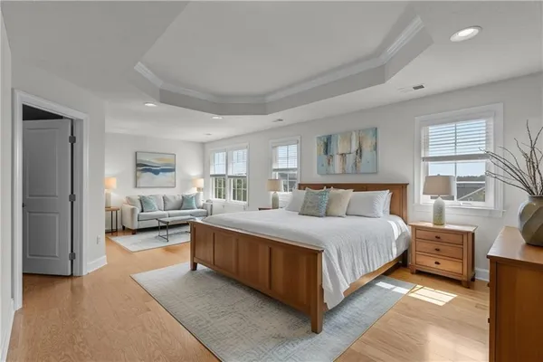 a spacious bedroom with a bed and a large window