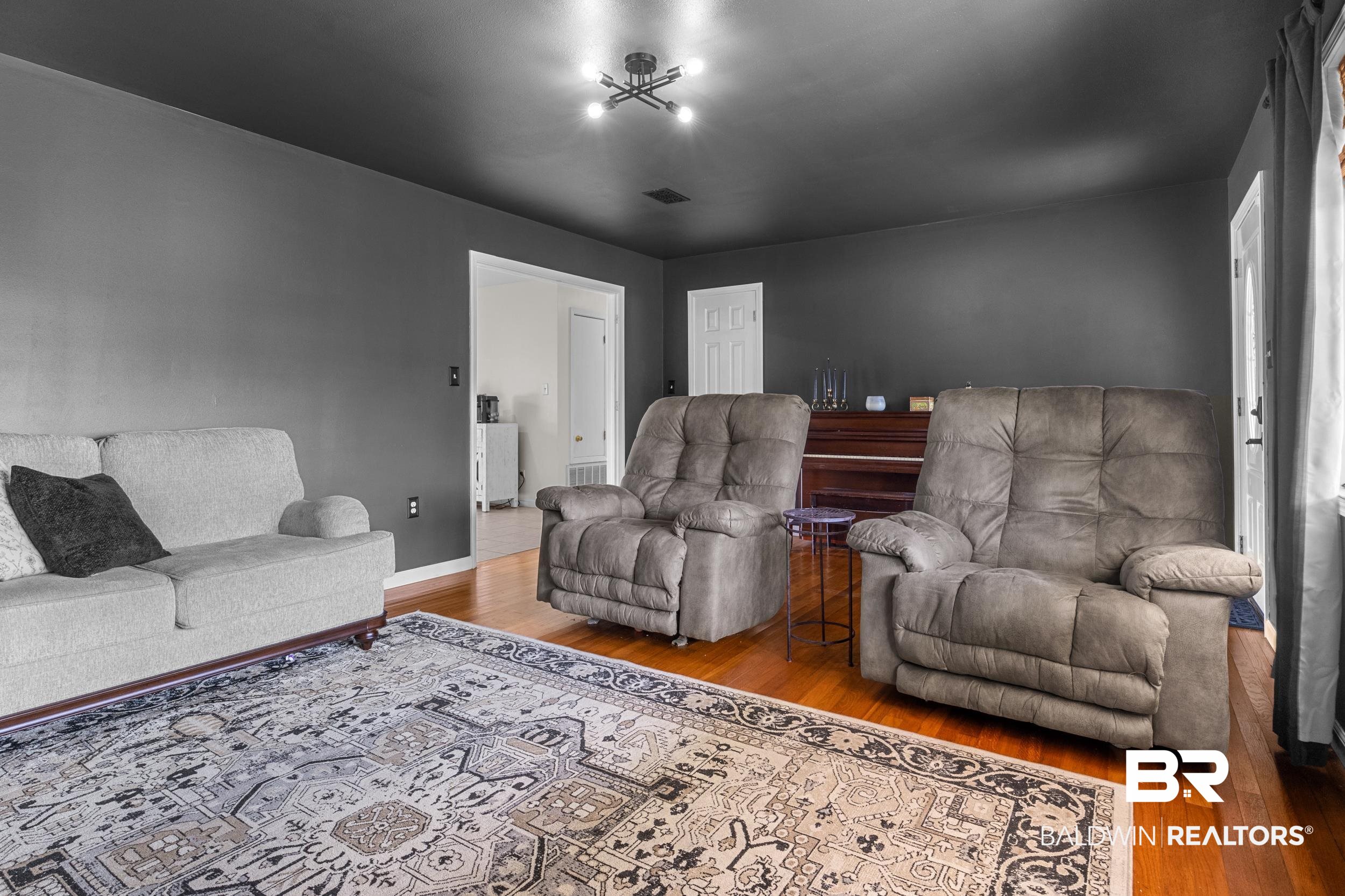17689 Brewer Road Foley, AL 36535 - Photo 32 of 54 Living room featuring a chandelier and hardwood / wood-style floors