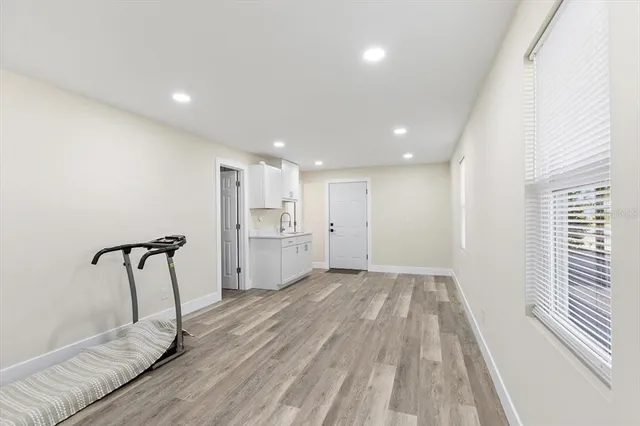 a view of empty room with wooden floor