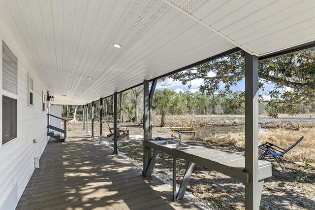 a view of a patio with wooden floor and outdoor seating