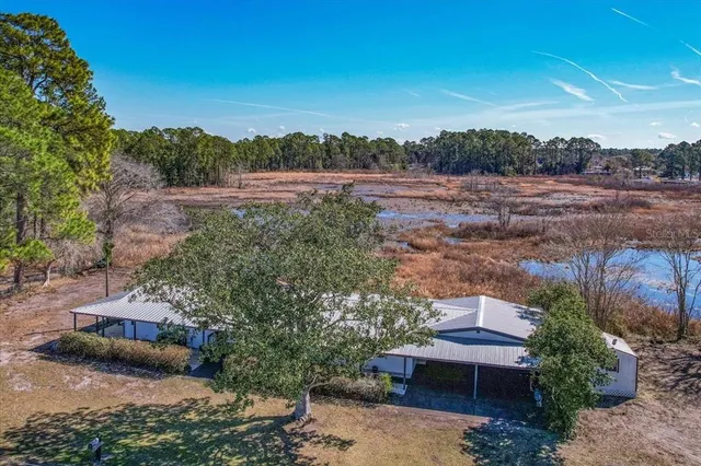 an aerial view of a house with a yard
