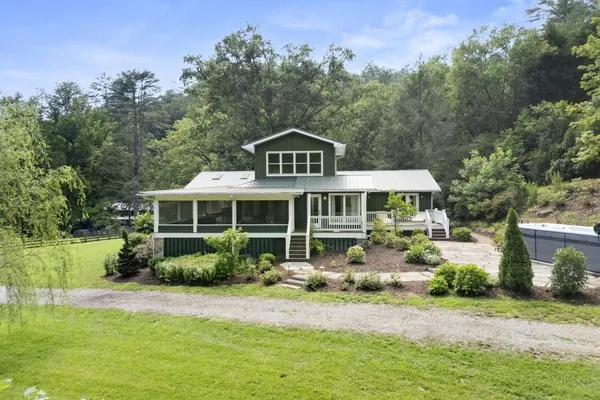 a kitchen with stainless steel appliances white cabinets and a window