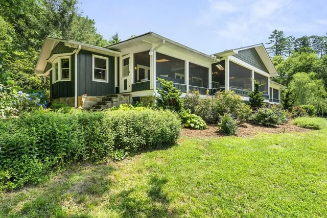a bathroom with a granite countertop sink and large window