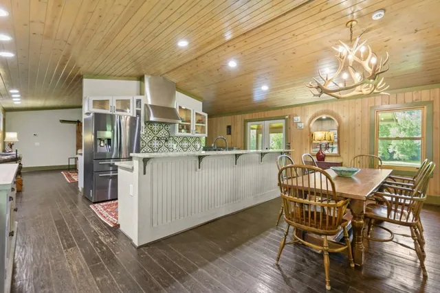 a living room with furniture fireplace and wooden floor