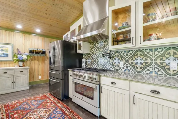 a spacious bedroom with a bed and glass table