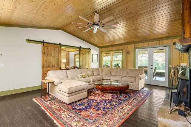 a view of a balcony with wooden floor and outdoor seating