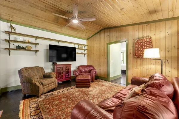 a view of a patio with table and chairs potted plants with wooden fence
