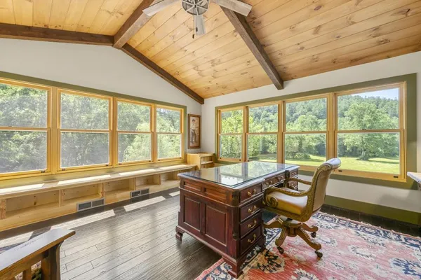 a view of a green field with wooden fence