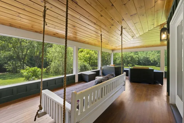 a view of a balcony with floor to ceiling windows and wooden fence