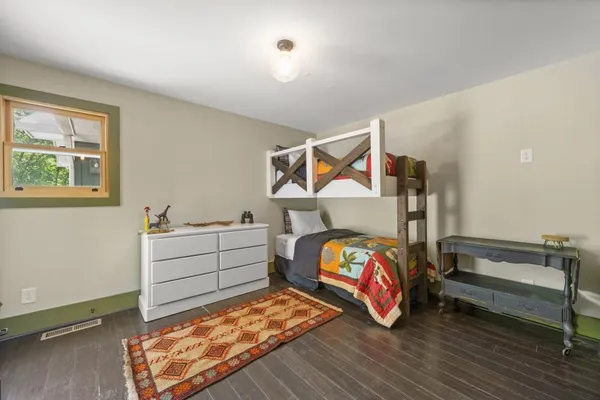 a view of a green yard with a house in the background