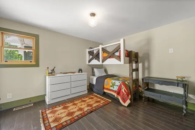 a view of a green yard with a house in the background