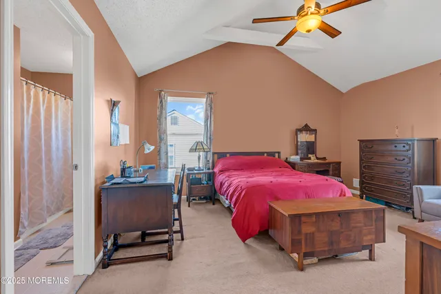 a spacious bedroom with a bed and a dresser