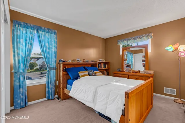 a room with a bed and a dresser