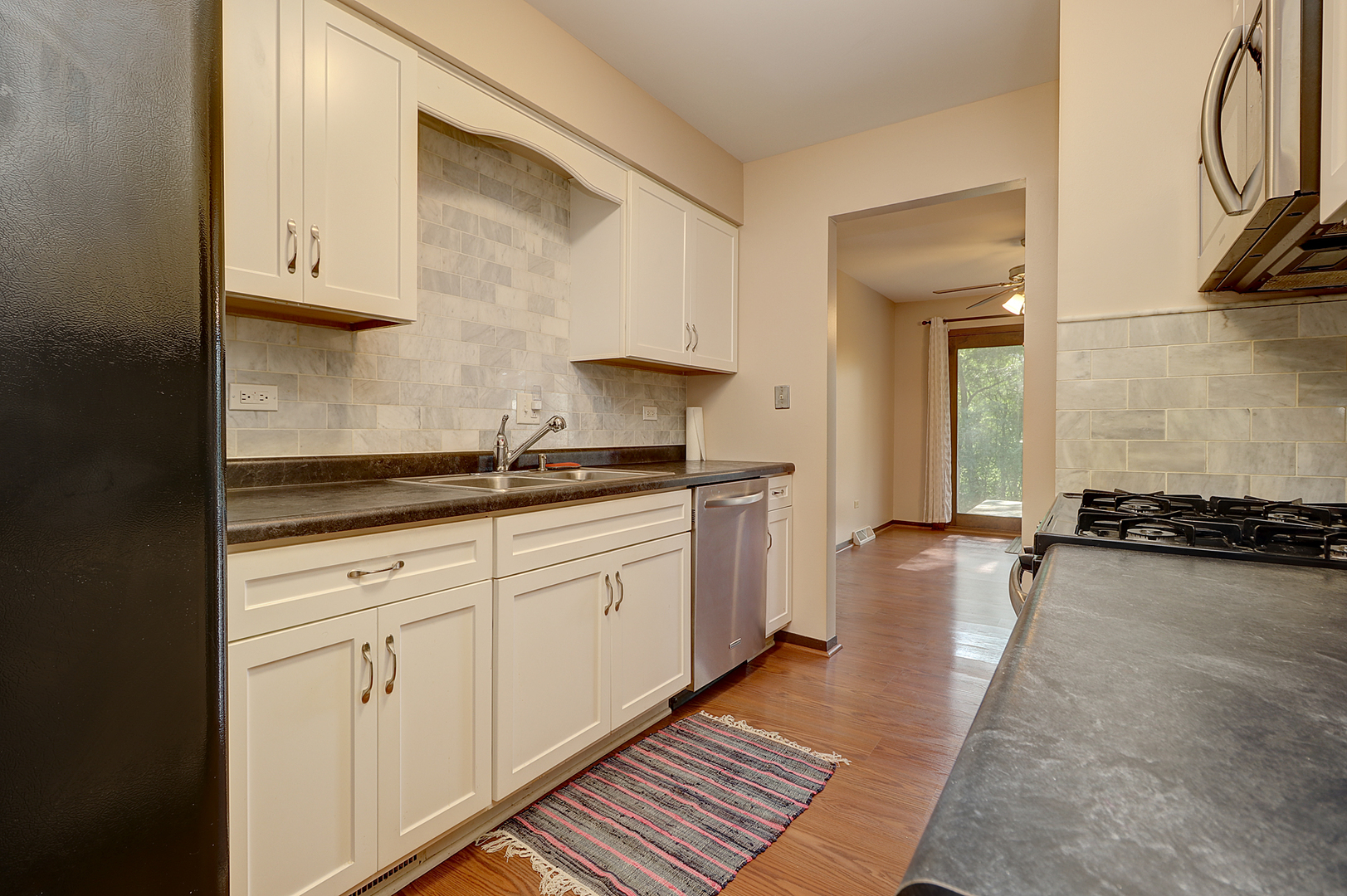 14801 South Penn Road Plainfield, IL 60544 - Photo 5 of 18 a kitchen with sink and cabinets