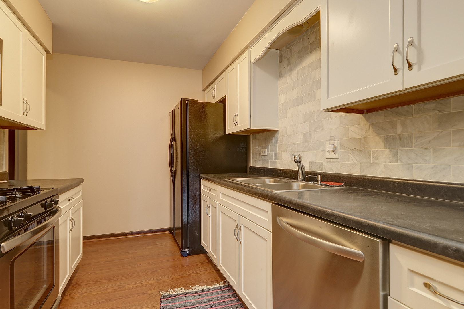 14801 South Penn Road Plainfield, IL 60544 - Photo 6 of 18 a kitchen with stainless steel appliances granite countertop a sink stove and refrigerator