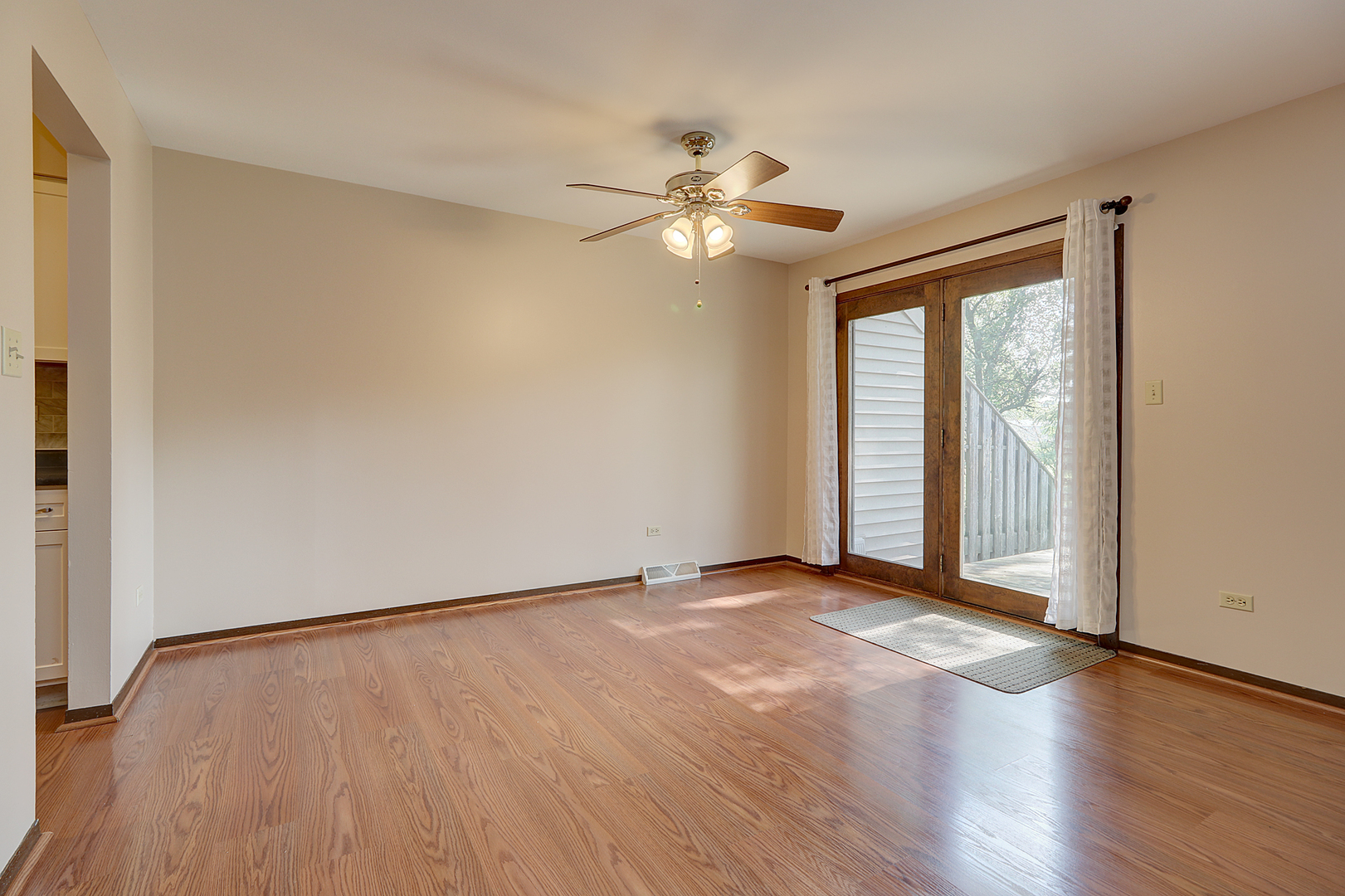 14801 South Penn Road Plainfield, IL 60544 - Photo 8 of 18 an empty room with wooden floor fan and windows
