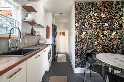 a kitchen with stainless steel appliances granite countertop a sink and cabinets