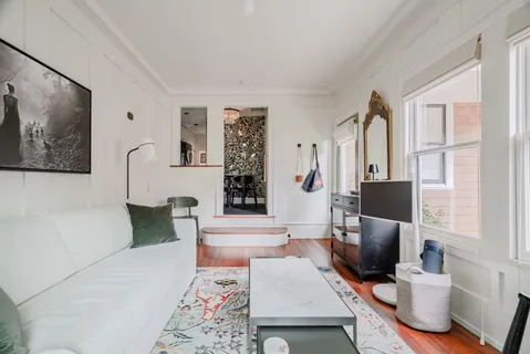 a living room with furniture a large window and a flat screen tv