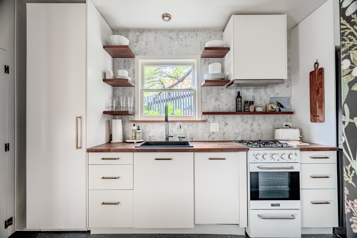 904 Avondale Road Austin, TX 78704 - Photo 10 of 16 a kitchen with granite countertop a sink stainless steel appliances and cabinets