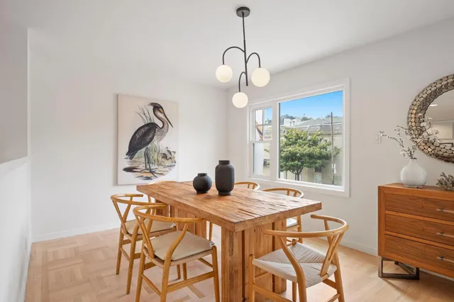 a view of a dining room and a table chairs and chandelier