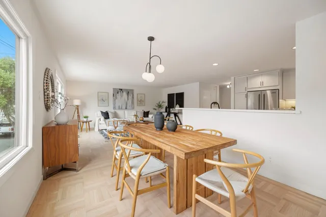 a view of a dining room with furniture and a chandelier