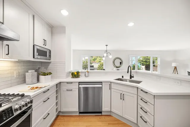 a kitchen with a sink stove and cabinets