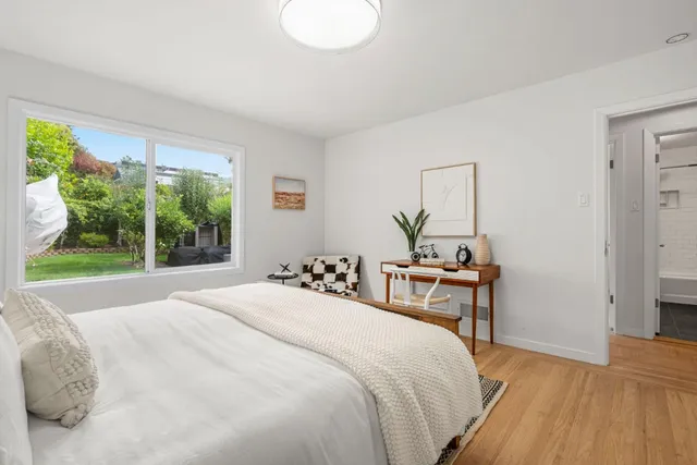 a bedroom with a bed and a table