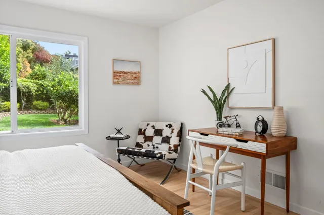 a room with a table chair and window