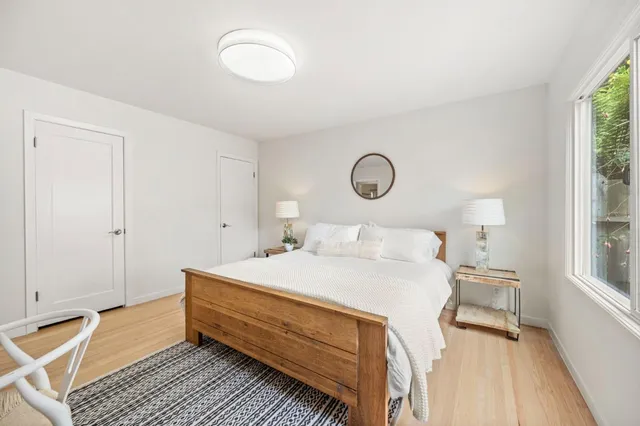 a bedroom with a bed and a window