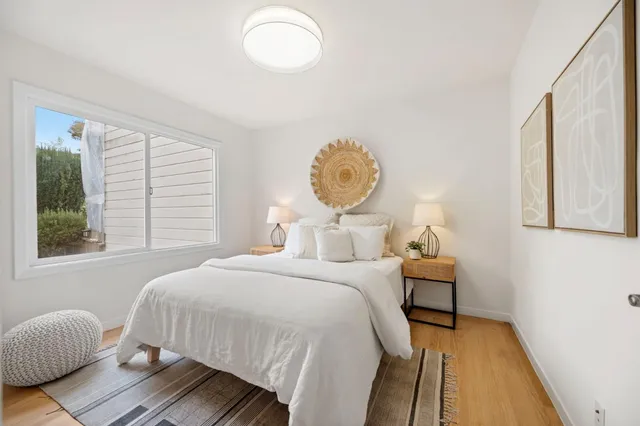 a bedroom with bed and a window