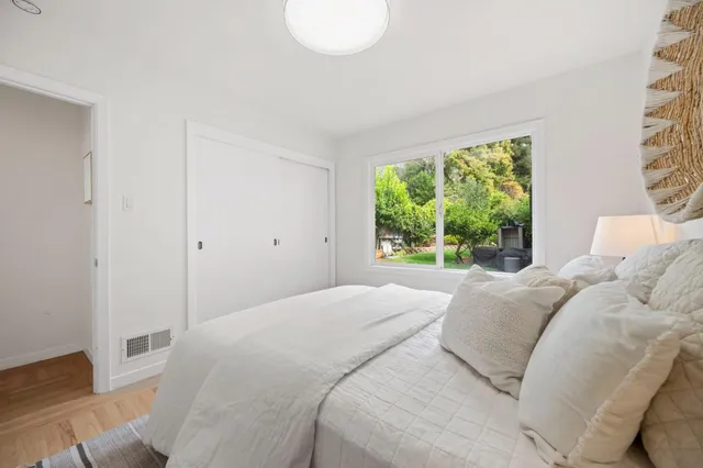 a bedroom with a large bed and a window