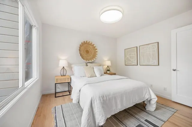 a bedroom with bed and a window