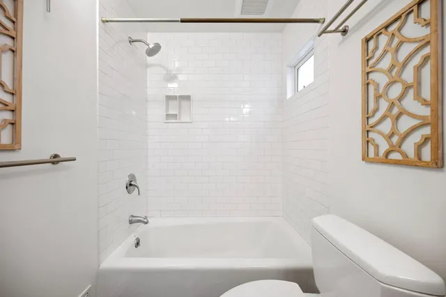 a bathroom with a bathtub and shower