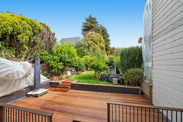 a view of a porch with furniture and garden